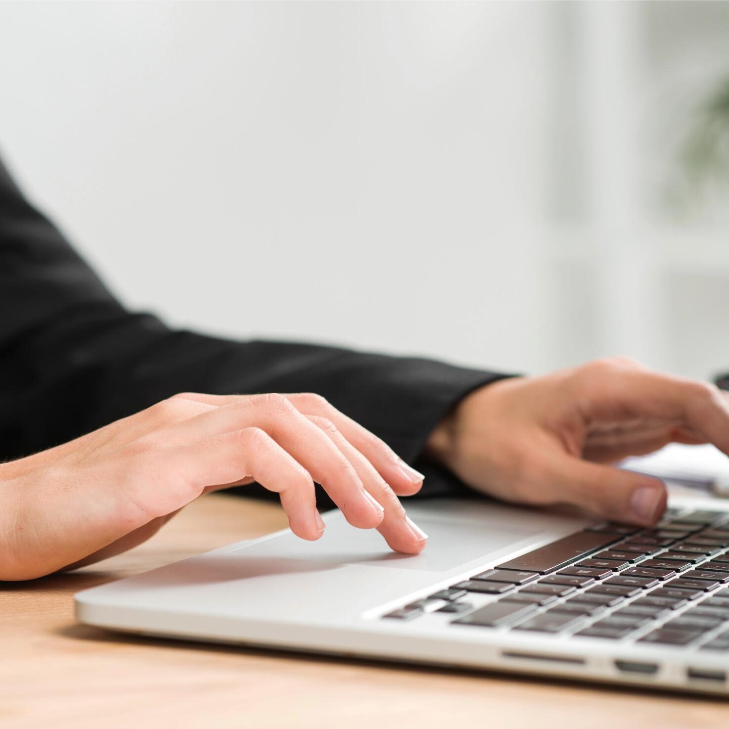 close-up-businesswoman-s-hand-typing-laptop-desk